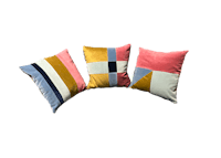 three colorful pillows on a black background