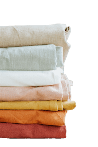 a stack of colored linens on a black background